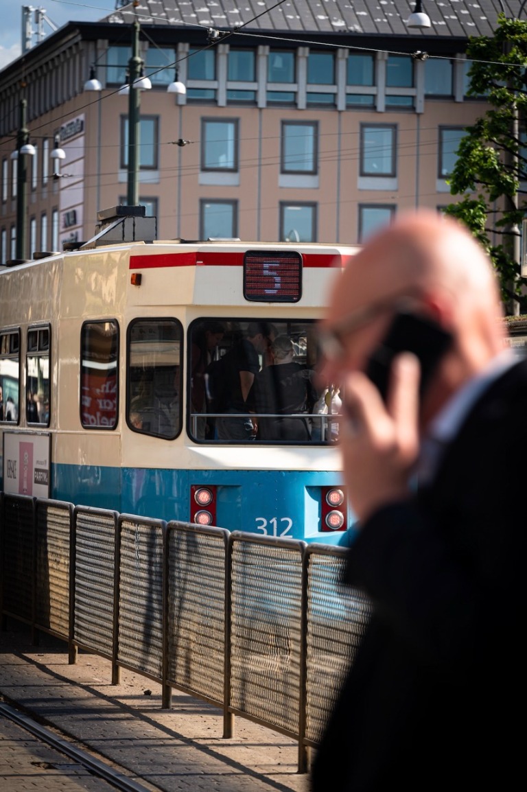 A tram passing by a city street
